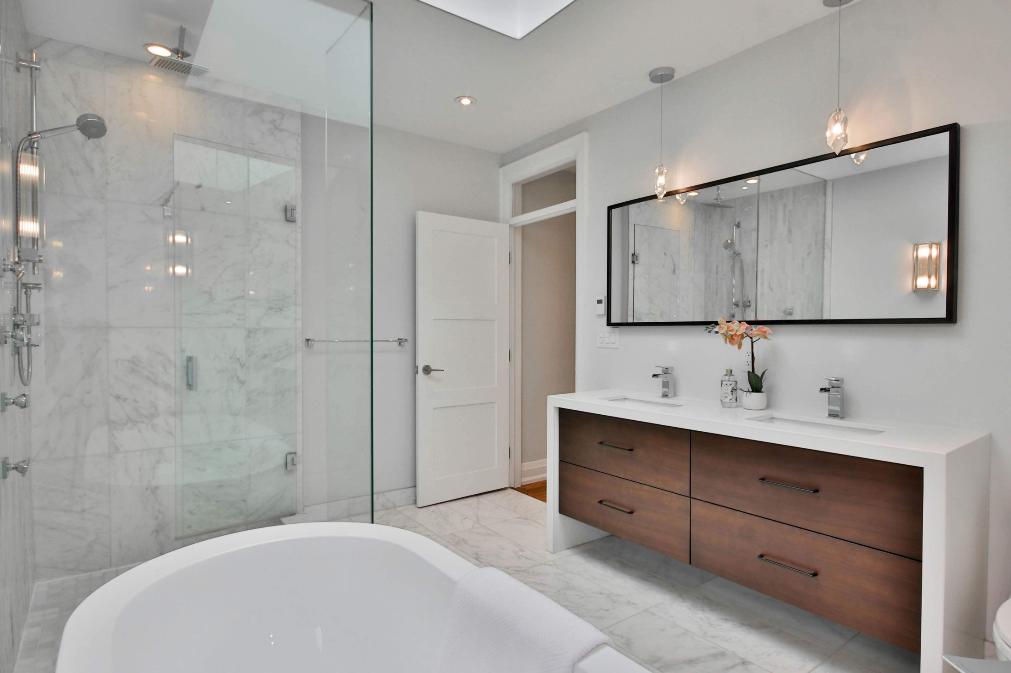 Luxury modern bathroom renovation with walk-in rain shower by Prime Bath Studio