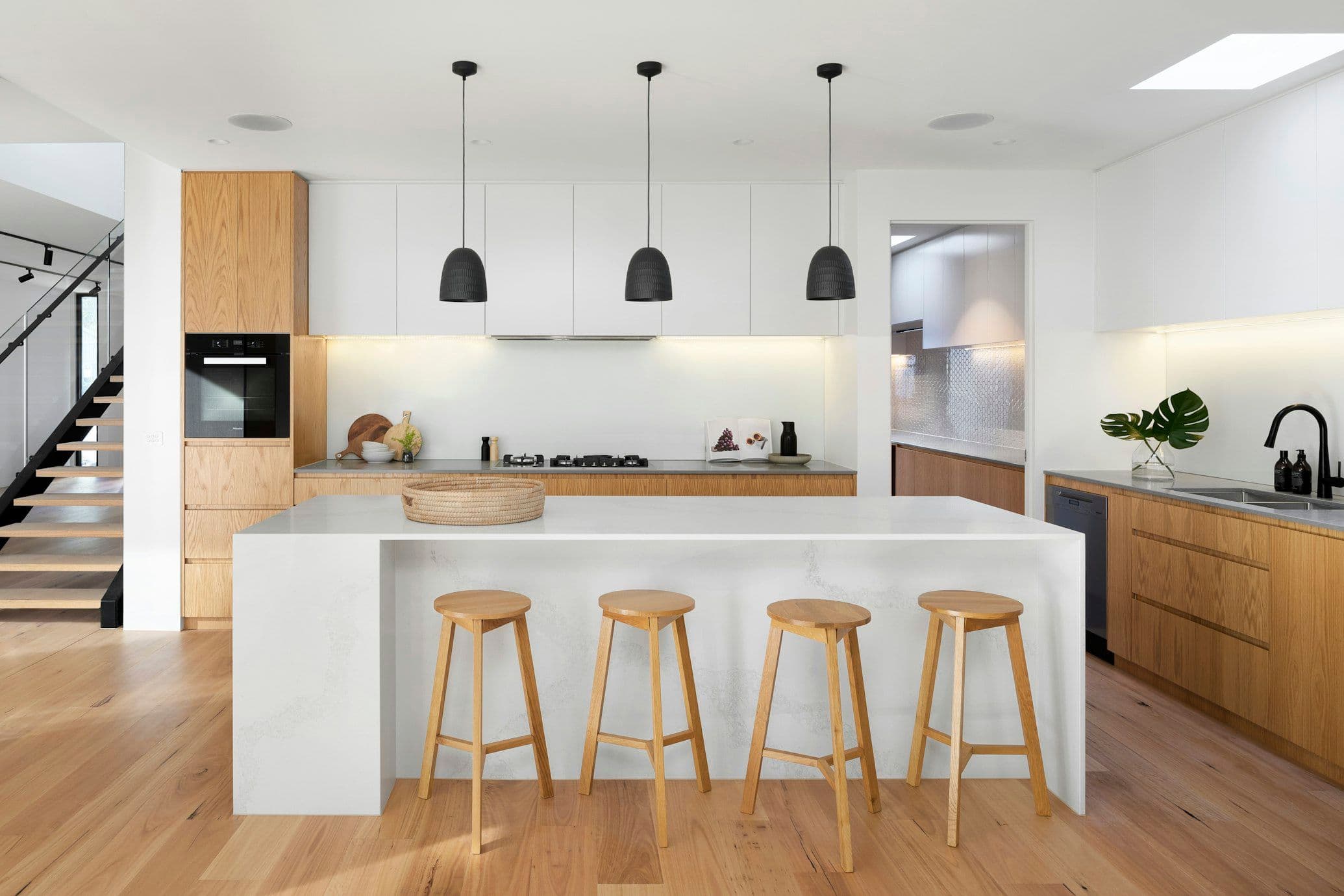 Contemporary bespoke kitchen installation with quartz waterfall island by Prime Bath Studio