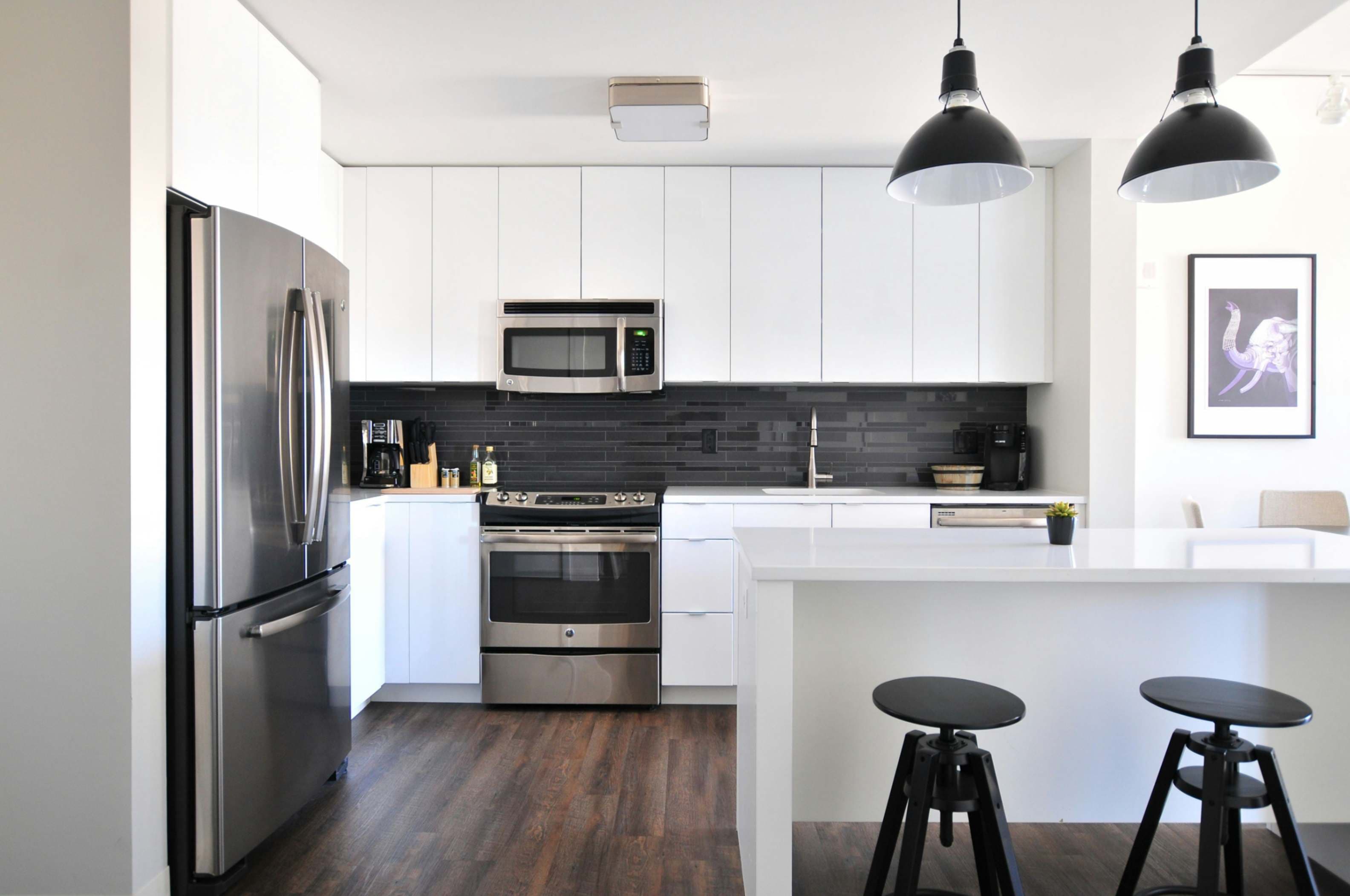 Modern open-plan kitchen fitting with premium custom cabinetry by Prime Bath Studio